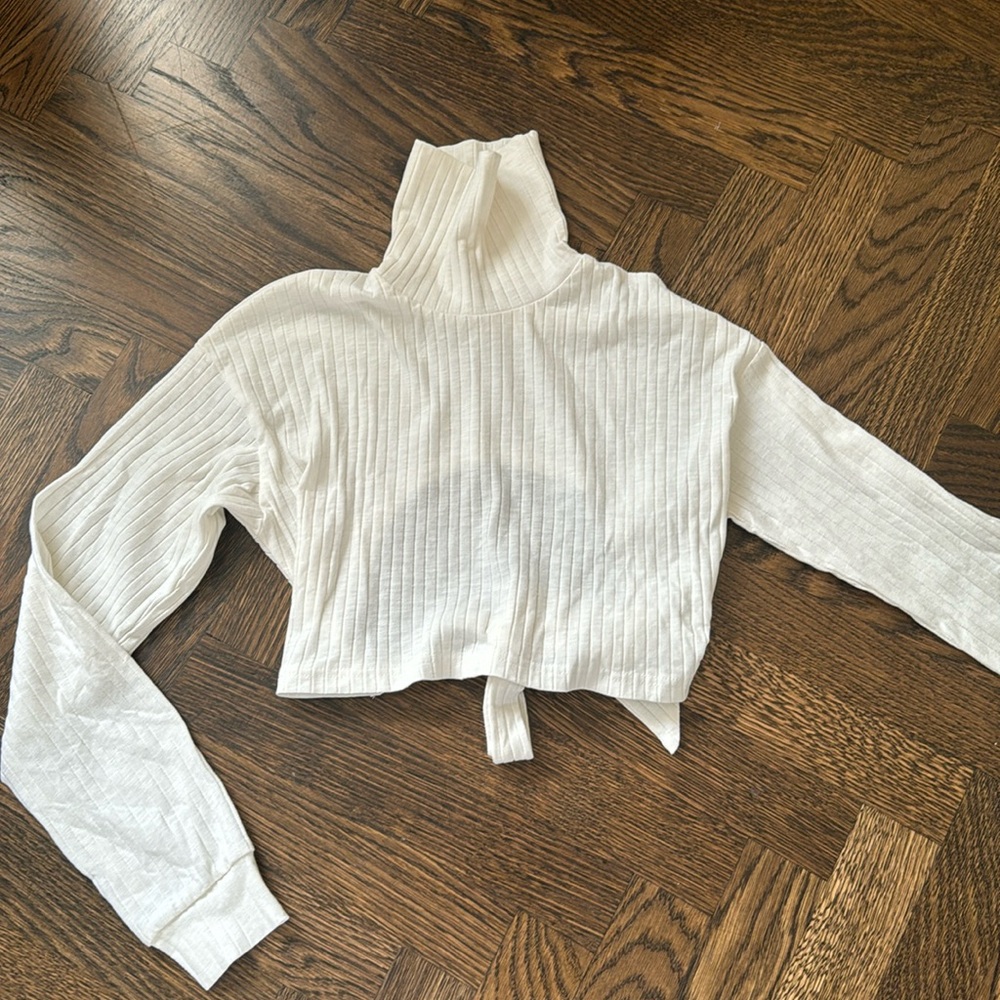 Crop white turtle neck white an open back.